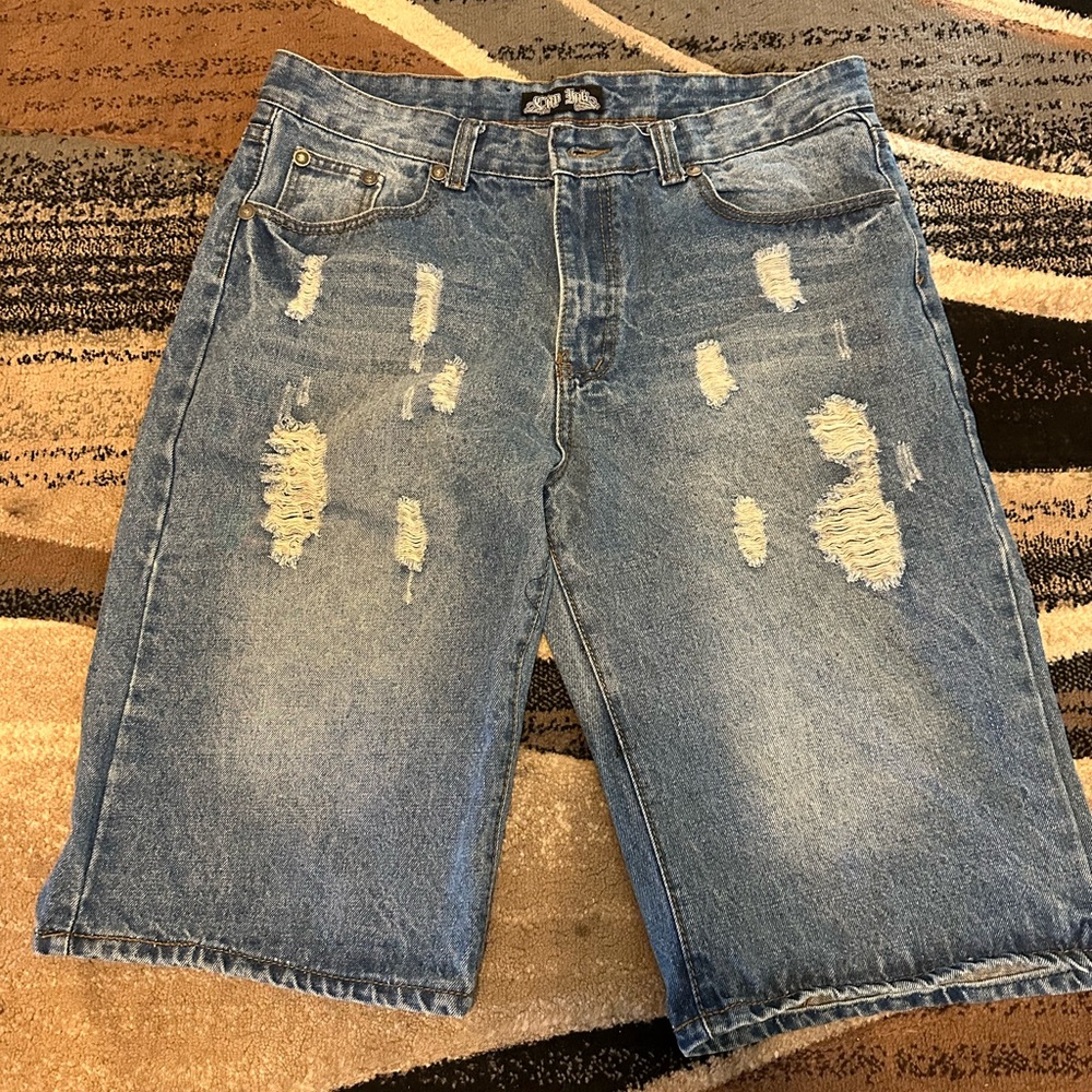 Men’s blue Jean ripped shorts.